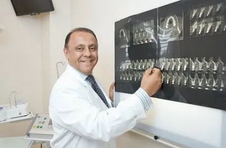 Dr. Sam Gilani reviewing dental imaging in his office